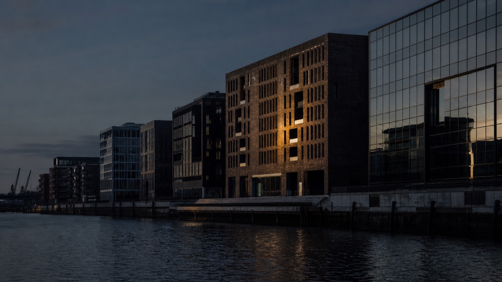 Hamburg HafenCity at dusk — modern brick architecture meeting glass curtain walls